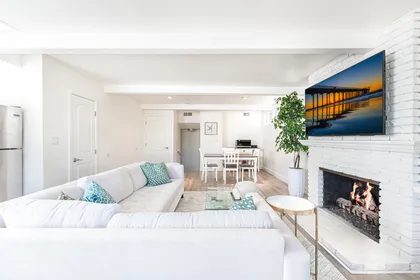 The view of the living room and dining area from the front sliding glass doors.