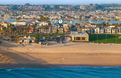 A stunning aerial perspective showcasing the home’s prime spot between the bay and the beach