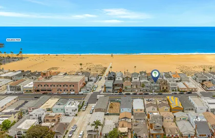 Aerial view highlighting your prime coastal location with the beach just steps away and sweeping ocean views beyond