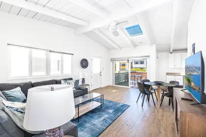 The open floor plan between dining, living, and kitchen areas allows for easy group hangouts after a day at the beach.