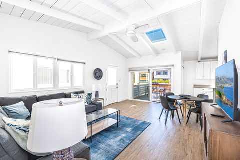 The open floor plan between dining, living, and kitchen areas allows for easy group hangouts after a day at the beach.