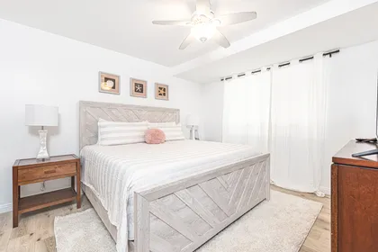 The primary bedroom includes a king bed, TV, and en suite bathroom.