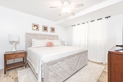 The primary bedroom includes a king bed, TV, and en suite bathroom.