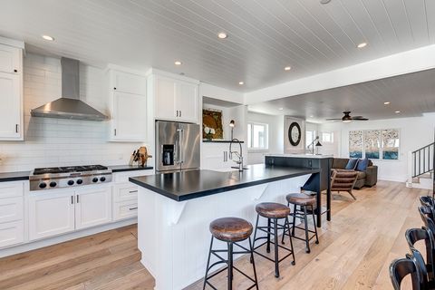 The second-level kitchen includes a spacious island with bar stools, making meal prep a social affair!