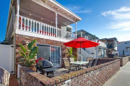 Our coveted 35th Street downstairs patio provides ocean views from the front patio, four houses back from beachfront and boardwalk; includes outdoor dining, propane bbq grill, market umbrella.