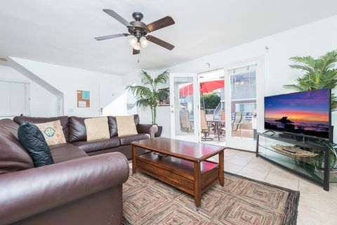 Living room of this downstairs unit looks out to front ocean view patio, with easy access through double French doors. Ceiling fans throughout.