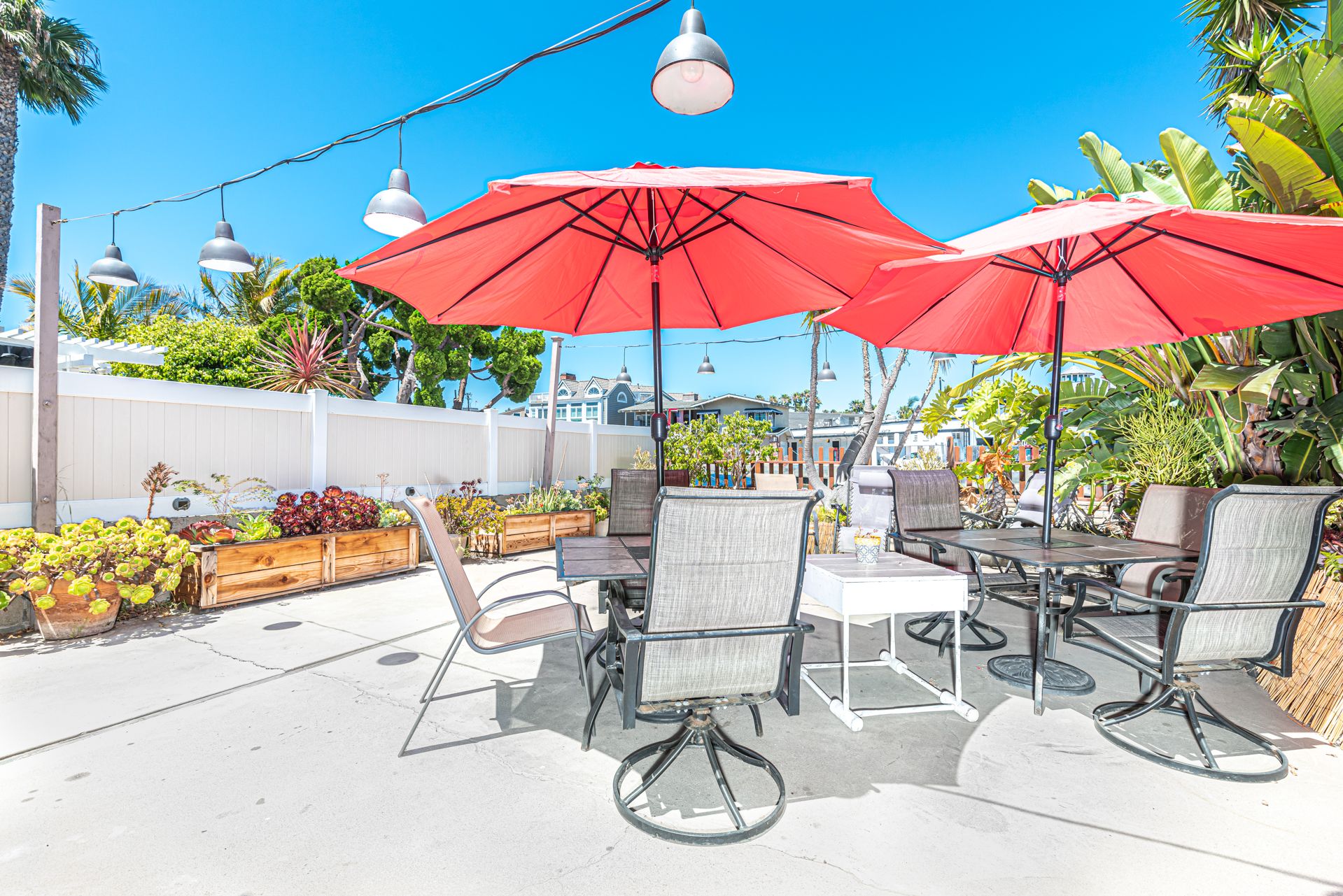 This two-story, single-family home is tucked away in its own bayside garden oasis on one of Newport Harbor’s side channels.