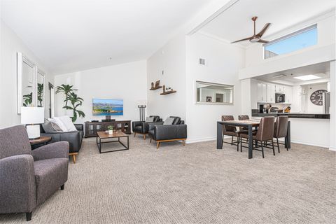 The living area includes sofa, side chairs, streaming tv, dining table with seating for 4, and kitchen beyond.