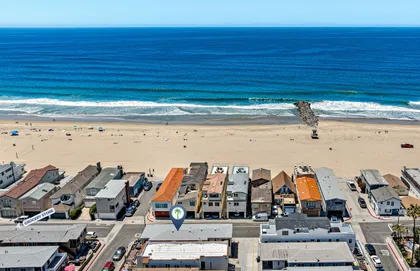 Sweeping aerial view of the beach and home just steps from the ocean
