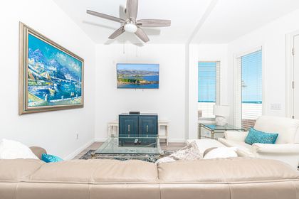 The main living area includes a sofa set and streaming cable TV.