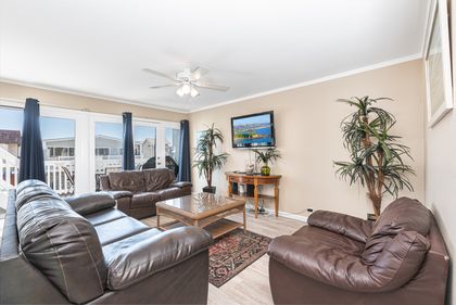 Bright and cheery open floor plan welcomes guests to this upper, ocean view unit. Ceiling fans throughout. French doors open up to front balcony and stairway leading to rooftop deck