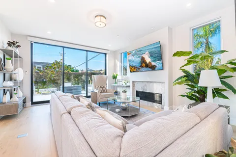 The living room seamlessly opens to the front patio for that wonderful indoor/outdoor lifestyle