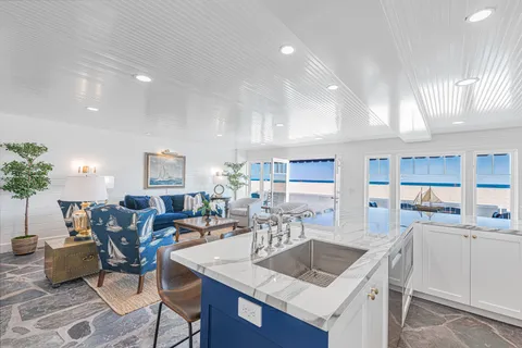Spacious kitchen with island seating and seamless flow to the ocean front living room