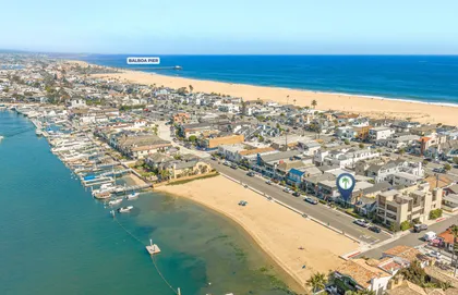 Sweeping aerial views where Newport Harbor meets the golden sands of the Peninsula.