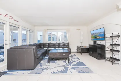 Spacious living and dining areas open up to the front balcony of this upper 4 bd/2 ba ocean view unit.