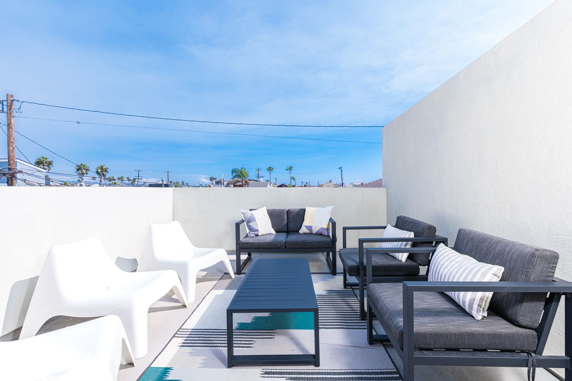 Large private deck with seating, accessed from third level rear bedroom.