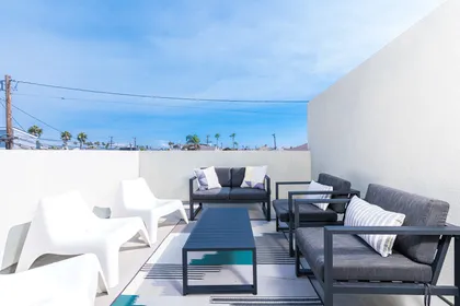 Large private deck with seating, accessed from third level rear bedroom.