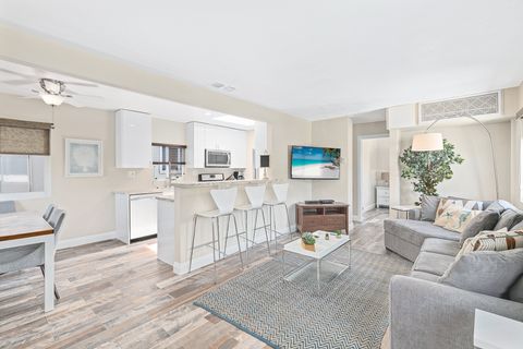 Bright and cheery, this spot is a guest favorite! The living room includes a sectional sofa, cable TV, and barstool seating for 3 at the adjacent kitchen counter.