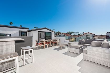 The rooftop deck is expansive and looks out on the idyllic streets of Corona Del Mar and ocean beyond
