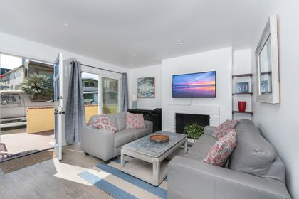 The living area's glass sliding door opens up to the patio, for the perfect indoor/outdoor living experience.