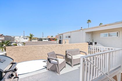 The outdoor space is located just outside the unit's entry door. It includes cushioned seating area for 4 and propane gas bbq grill. A shared outdoor shower is also on the property for easy sand clean-up.