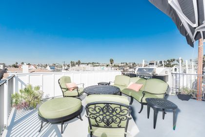 The glorious rooftop deck includes ample seating, propane BBQ grill, propane fire pit, and fresh ocean breezes.