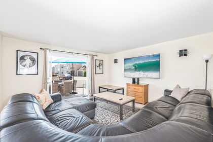 Living room looks out to front ocean view patio, with easy access through sliding glass doors.