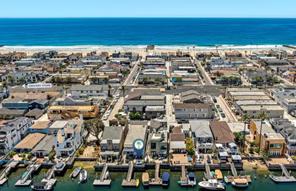Aerial view capturing the perfect bayside-to-beach location, with Newport Harbor in the foreground and the ocean just steps away