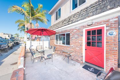 Front patio includes table with seating for 6 and propane BBQ grill.