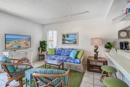 The main living area includes cable TV and plenty of seating to unwind after a day at the beach.