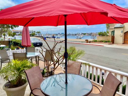 The front patio offers sweeping views of the bay, creating an inviting setting for morning coffee, sunset drinks, and relaxed coastal moments