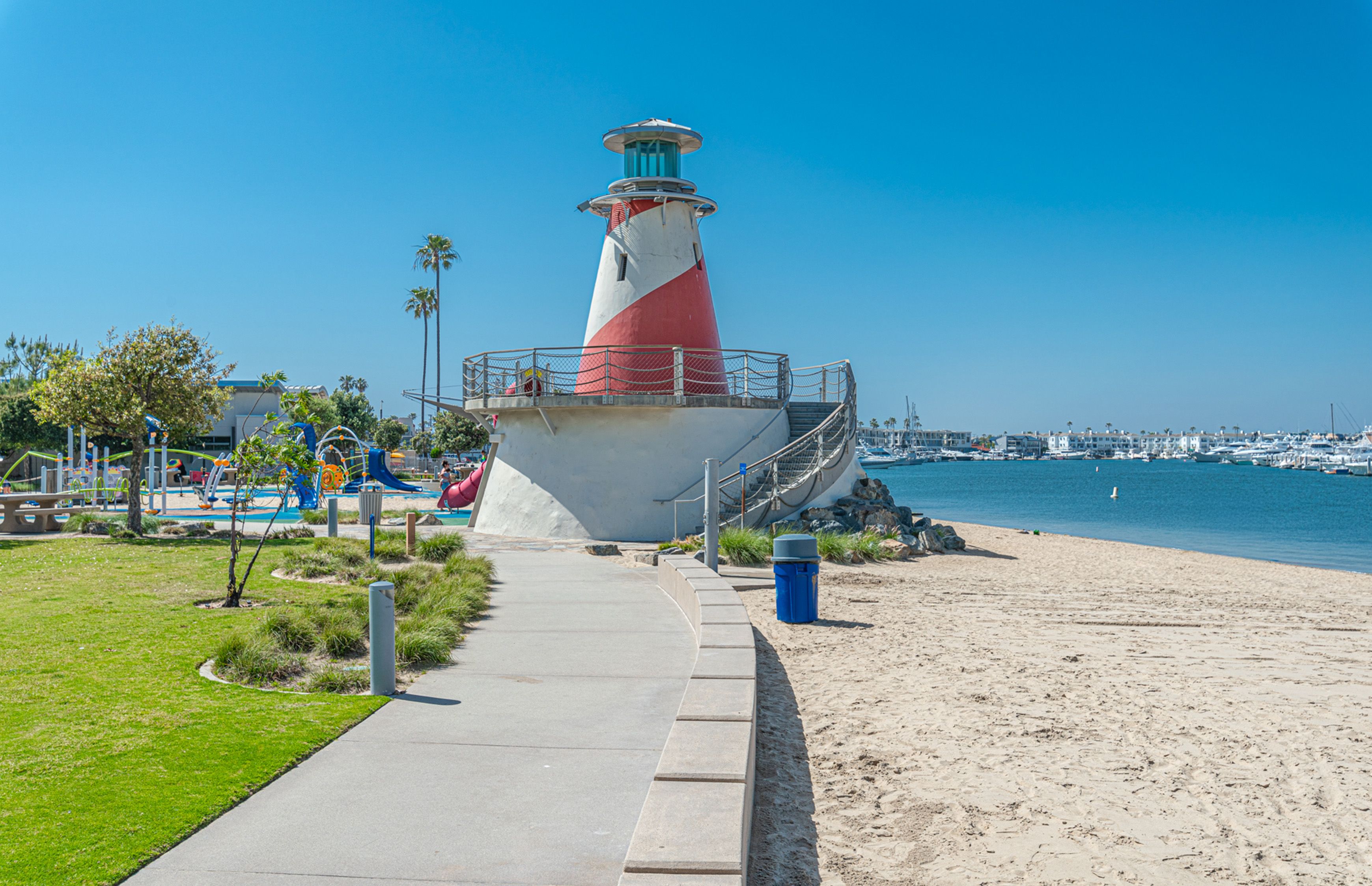 Marina Park in Newport Beach, where the iconic lighthouse, sandy shoreline, and sparkling harbor views come together