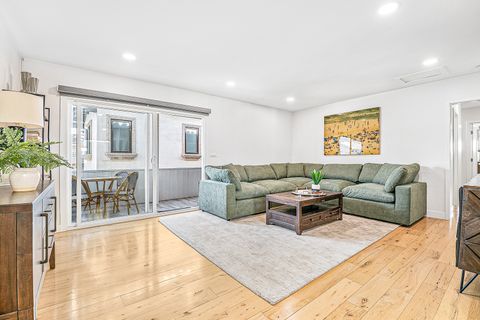 Spacious living room with large sliding glass doors that opening to a private balcony