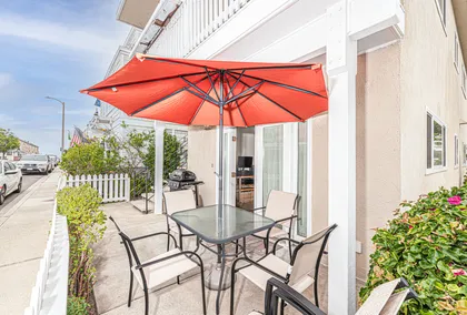 This listing pertains to the lower level unit only and includes a private front patio, complete with dining table, umbrella, and propane grill.
