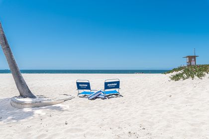 Feel the warmth beneath you as you watch the waves roll in.