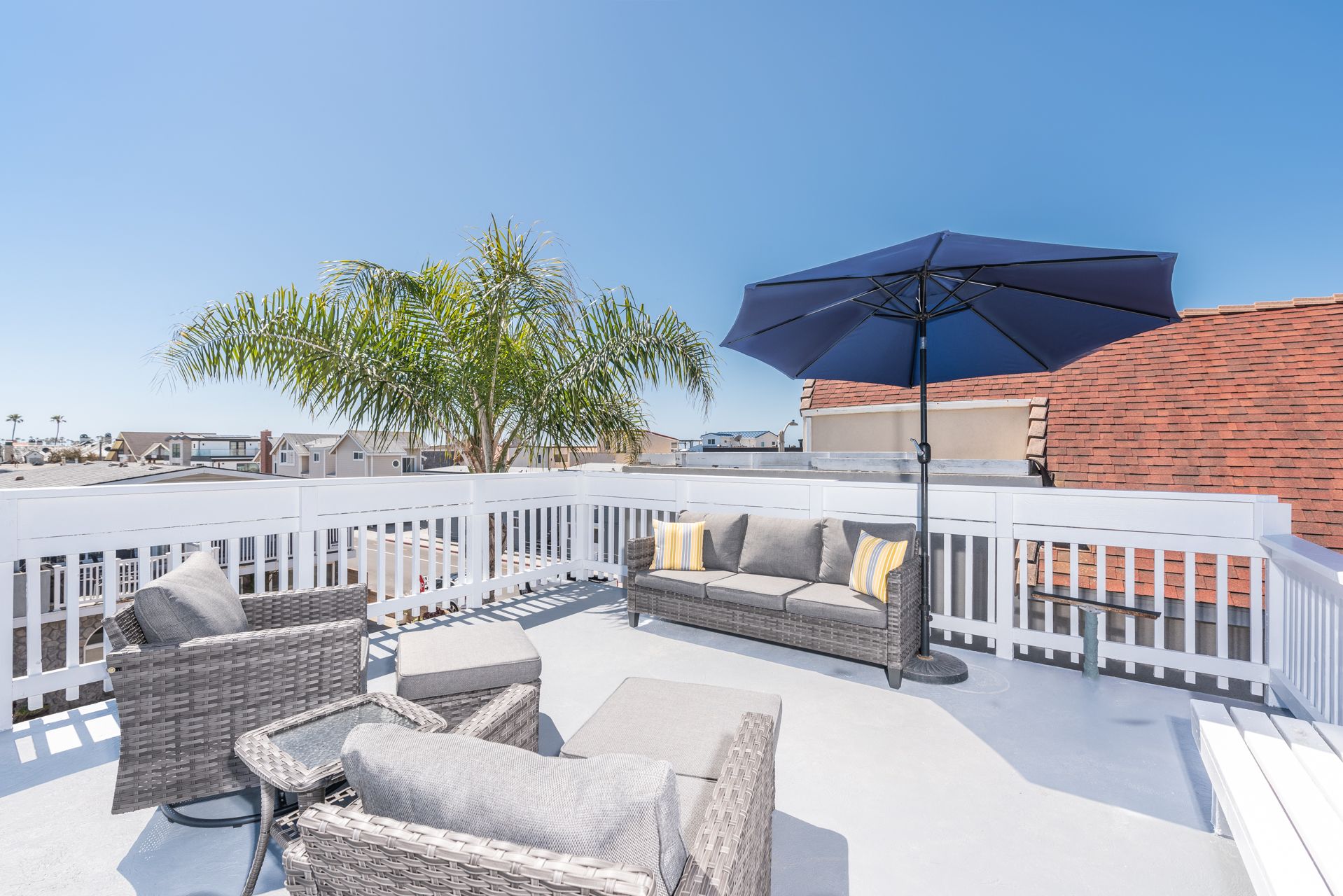 Exclusive rooftop deck with panoramic views includes ample seating.