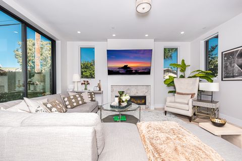 The ground floor living room is professionally appointed for premium comfort and style, including streaming television and gas fireplace.