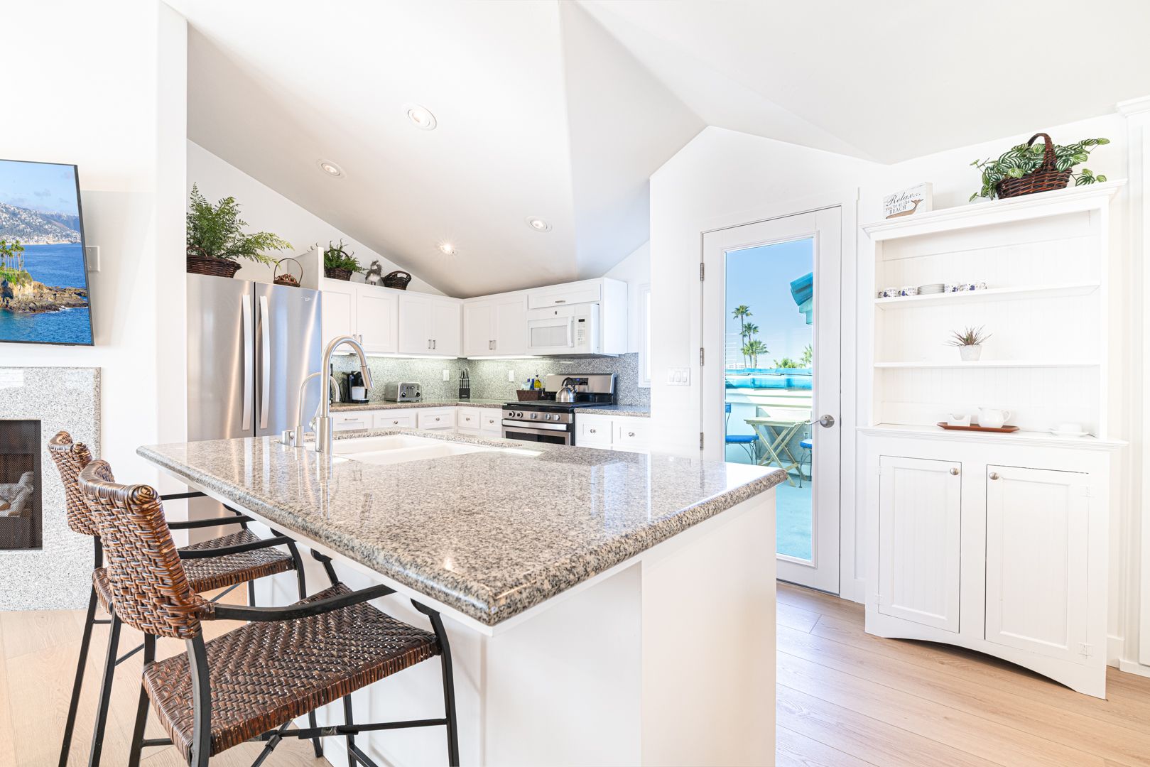 A bright, coastal kitchen where mornings begin over coffee at the island