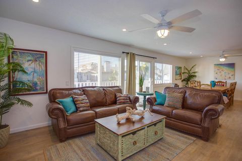 Main living spaces looking from front entry area. Open floor plan between living, kitchen and dining areas.