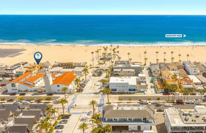 The home sits directly along the beachfront, with the sand and Pacific Ocean just outside