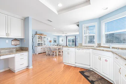 Kitchen includes built-in desk area and opens up to the main living area for fun, social meals.