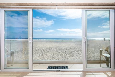 Sliding glass doors open to the balcony, which includes seating for 6 and a small electric BBQ grill.