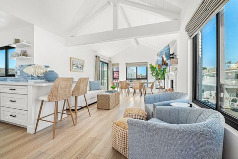 Relax in the airy living space with soaring ceilings, comfortable seating, and plenty of natural light for effortless coastal living