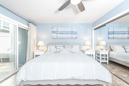 The primary bedroom is located on the first level & features a king bed, streaming TV, and en suite bathroom.