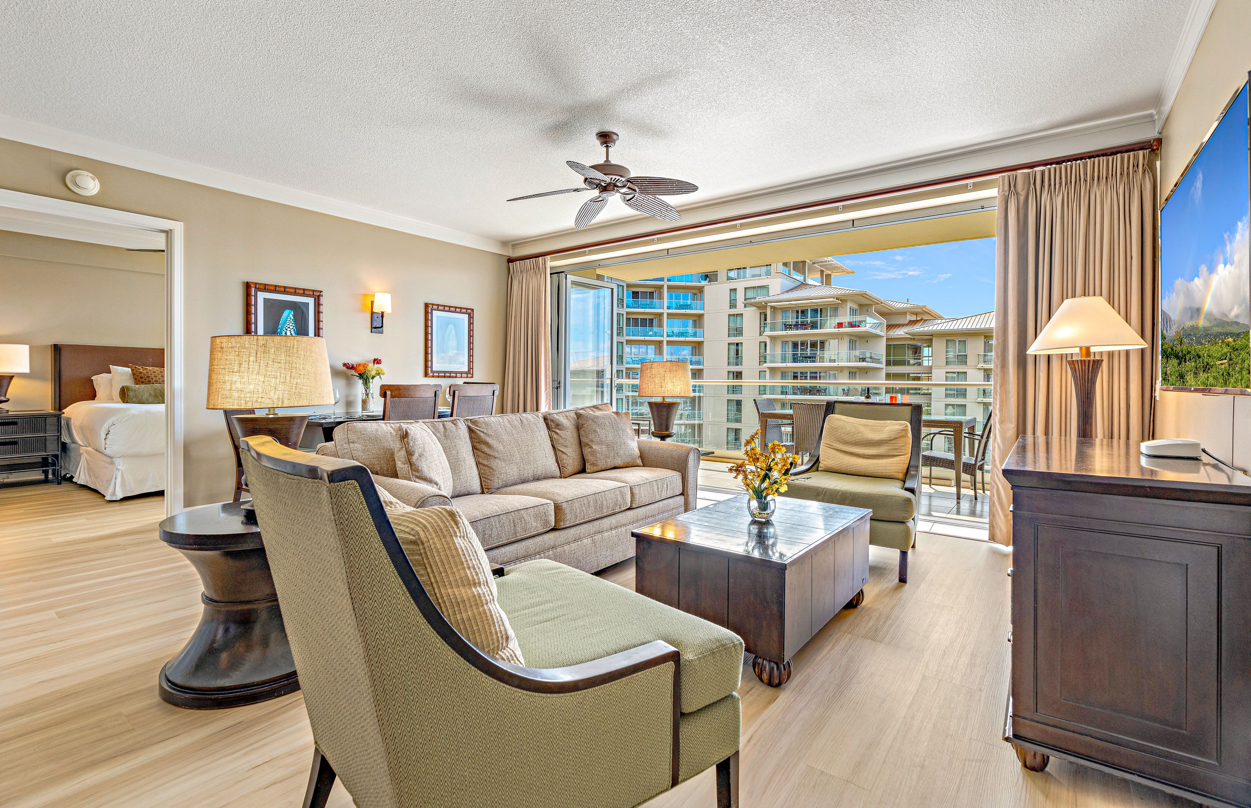 Bright, airy living space with floor-to-ceiling glass that opens to your private lanai and stunning Maui scenery.