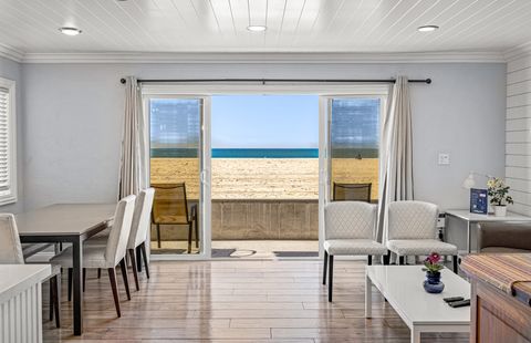 Sliding doors open from the main living area out to the front patio, boardwalk, and beach beyond!