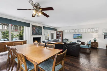 Enjoy the open-concept layout connecting the living room, kitchen, and dining area with seating for eight