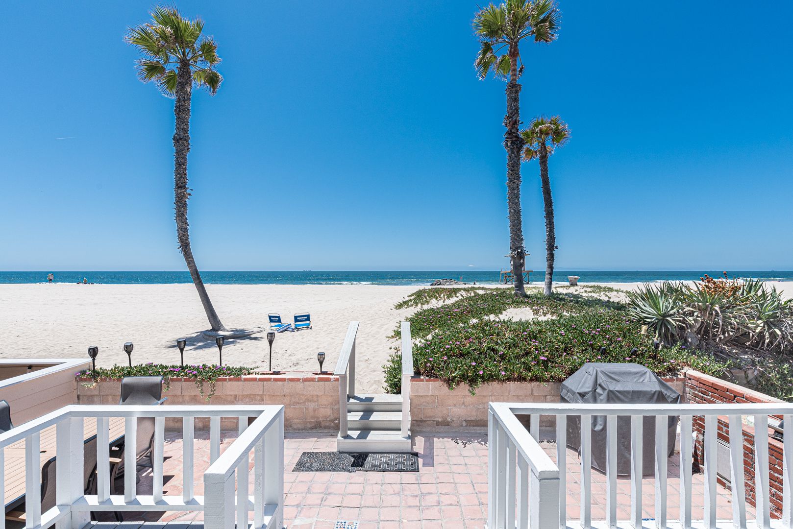 The outside patio, complete with a propane grill and a dining table for six.
