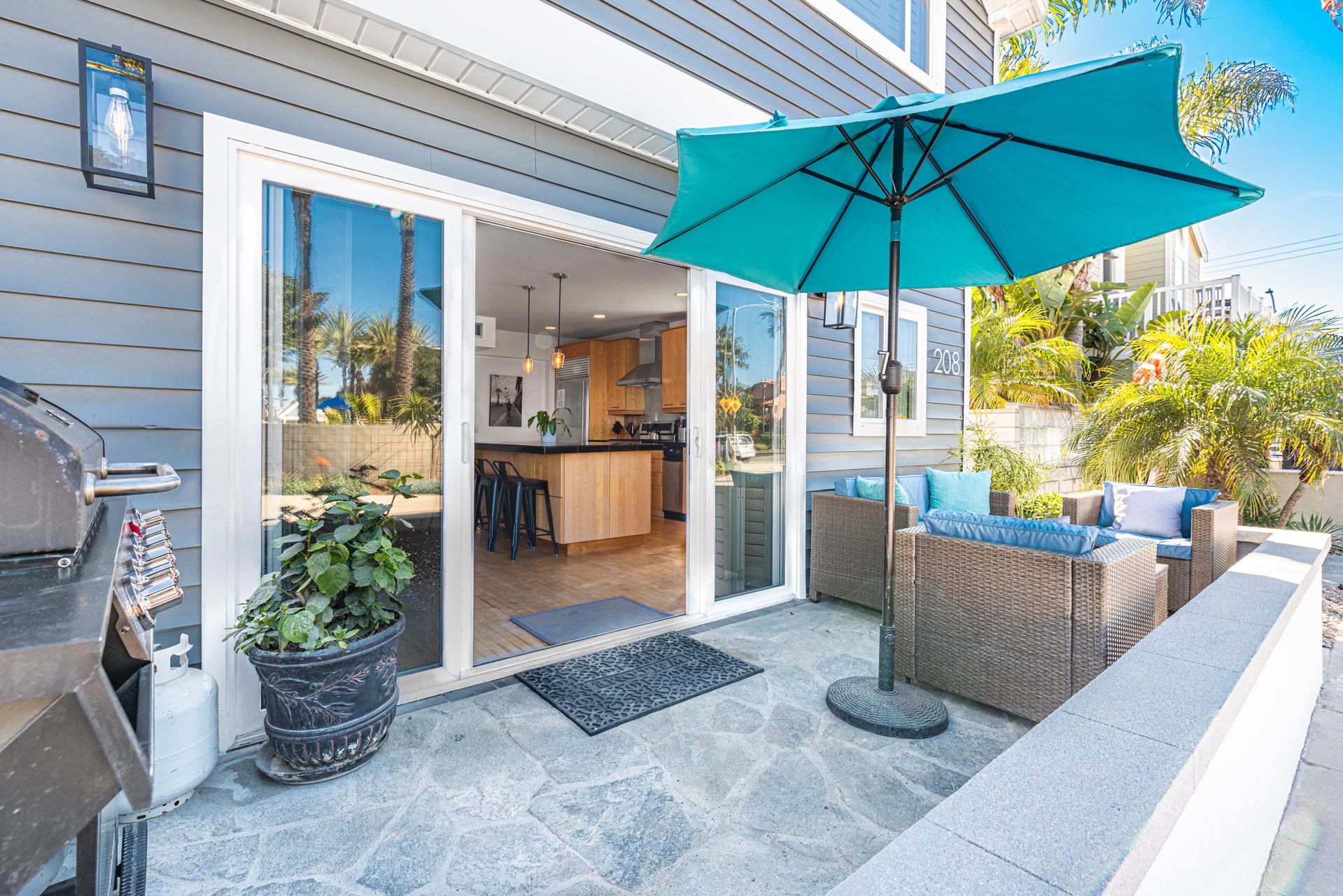 Front french doors open out to the front patio, with cushy seating and propane bbq grill.