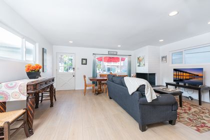 The main living area includes sofa, cable TV, and dining table for 6-8 that looks out onto the patio.